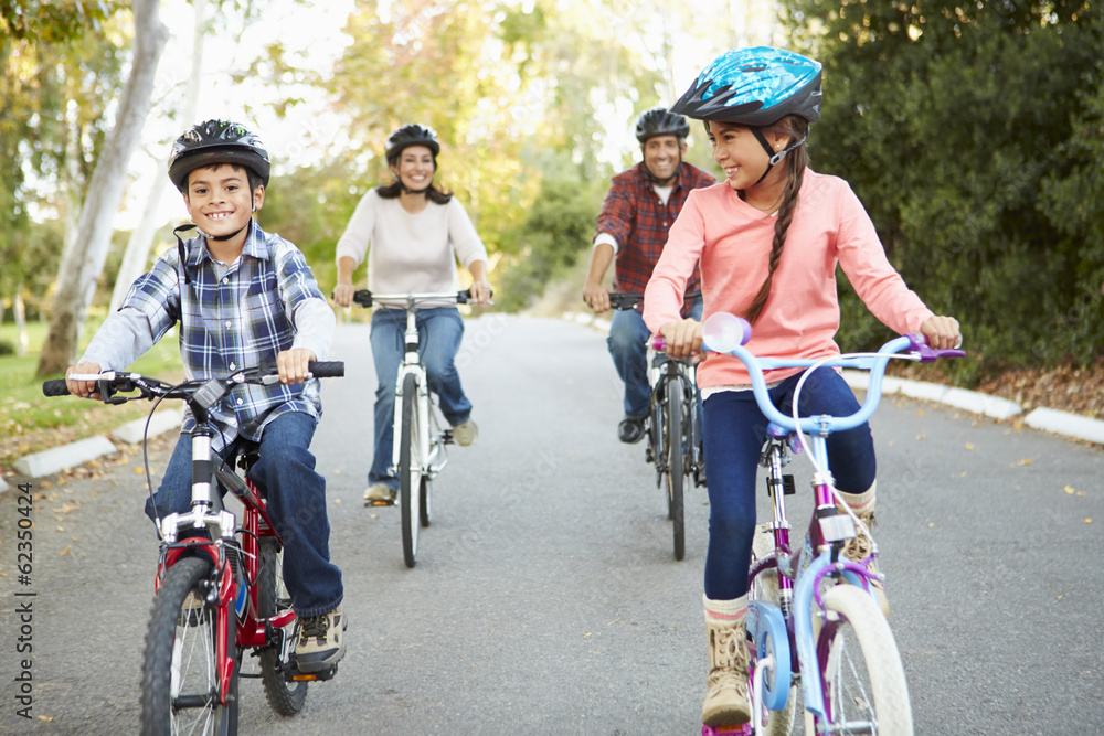 Fototapeta premium Hispanic Family On Cycle Ride In Countryside