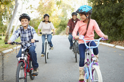 Hispanic Family On Cycle Ride In Countryside