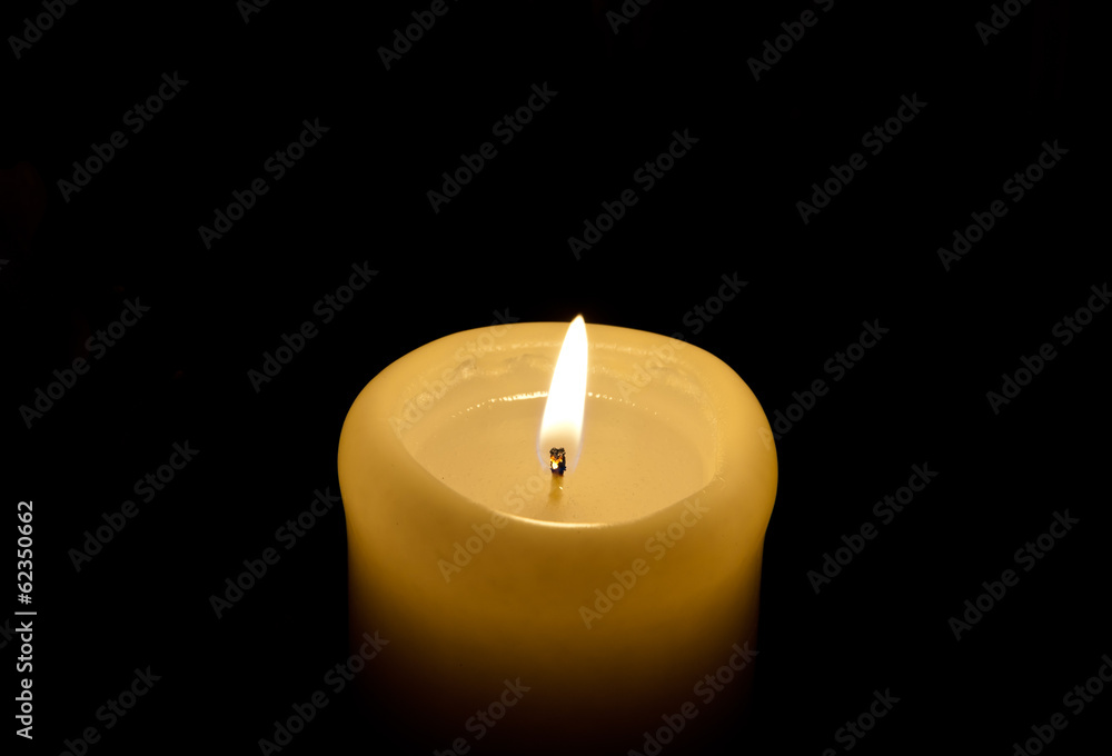 A candle lights up in the darkness A candle lights up in the darkness