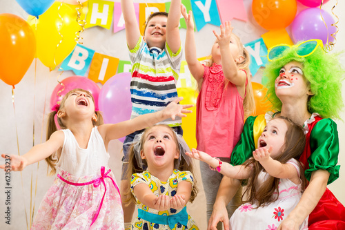 children group with clown celebrating birthday party