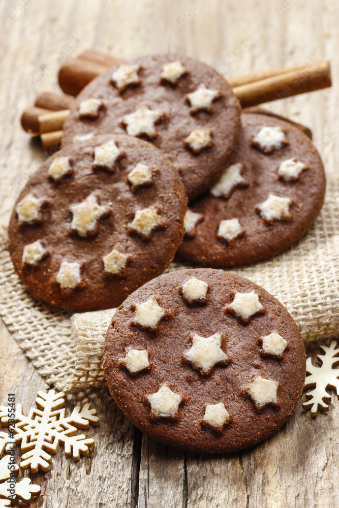 Round chocolate cookies decorated with icing stars