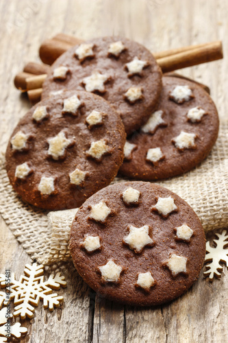 Round chocolate cookies decorated with icing stars