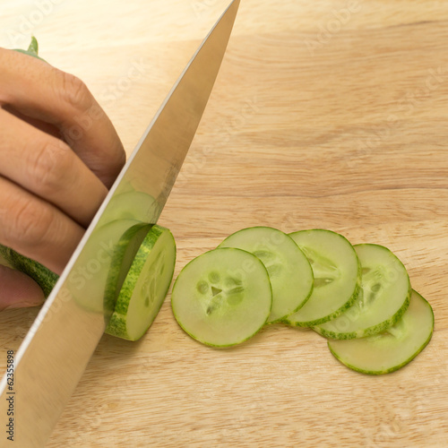 cucumber slices on wooden background