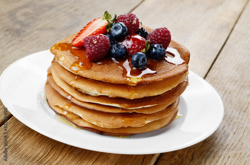 Pancakes with berries and honey closeup Pancakes with berries and honey closeup