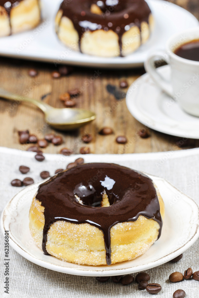 Delicious donut with chocolate on wooden table Delicious donut with chocolate on wooden table