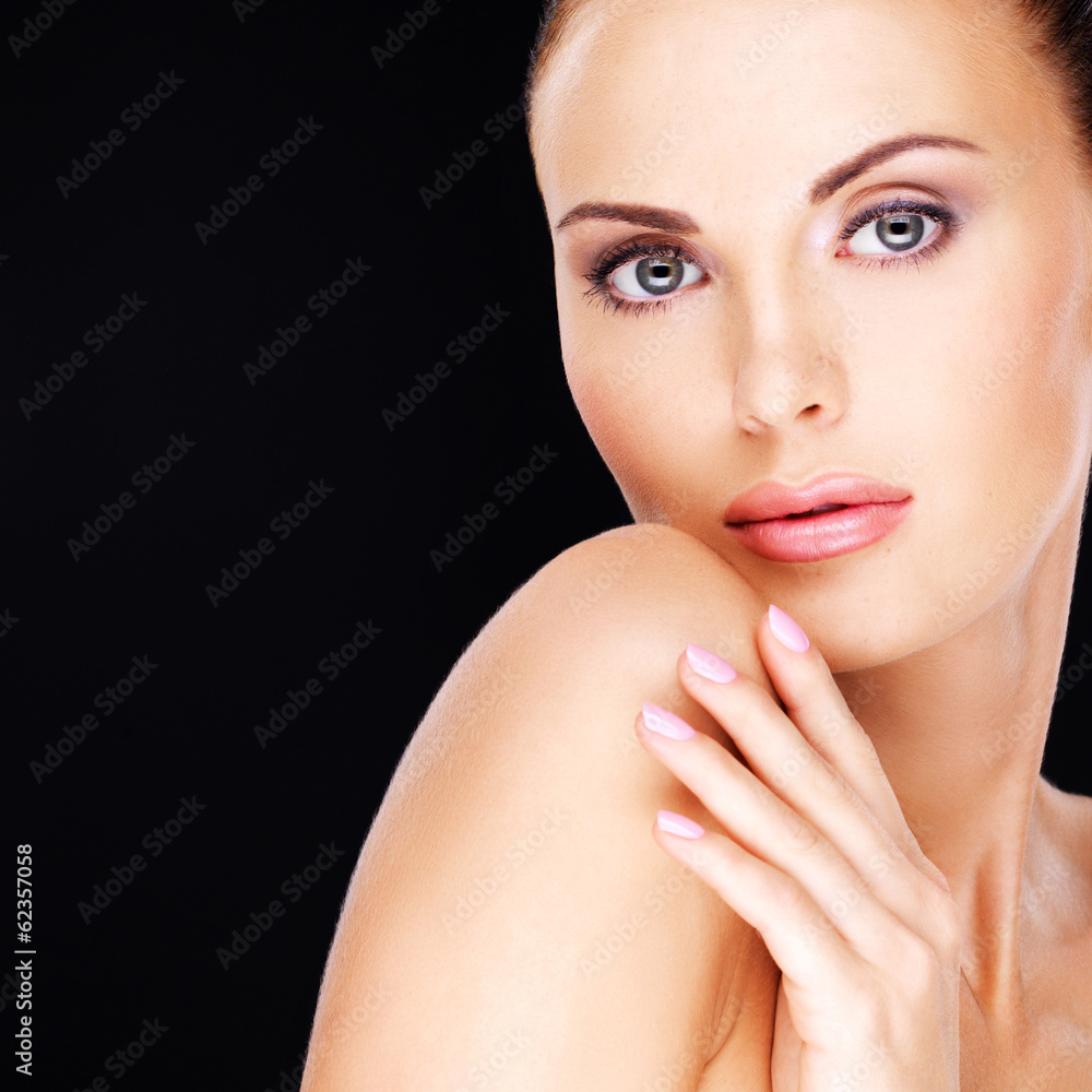 Naklejka premium Beautiful face of the adult woman with fresh skin