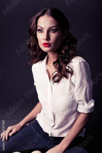 Lovely woman in white blouse and blue jeans 