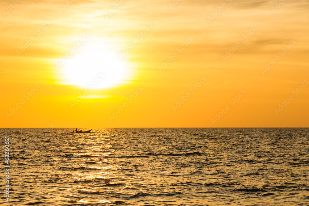 Fishing boat sail past the sun