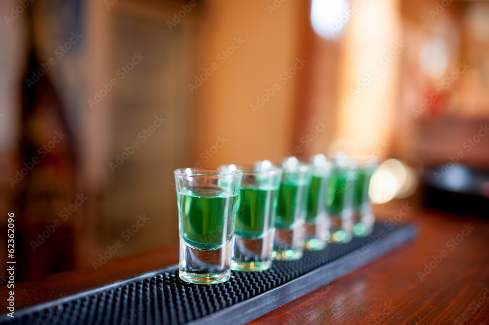 alcoholic shots of different drinks at a party in a nightclub