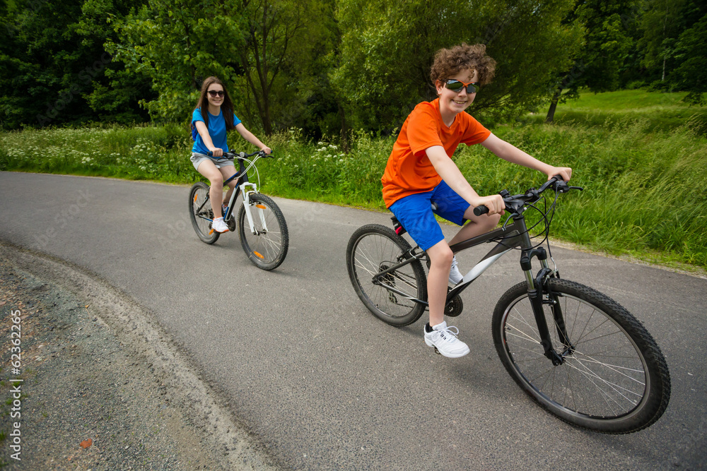 Healthy lifestyle - teenage girl and boy biking Healthy lifestyle - teenage girl and boy biking