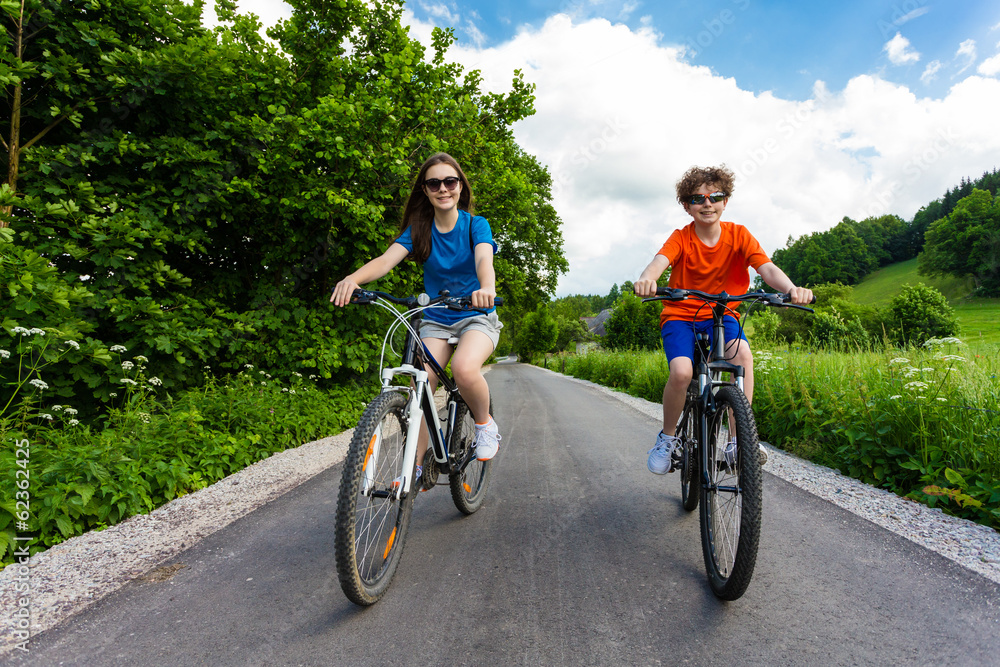 Healthy lifestyle - teenage girl and boy biking Healthy lifestyle - teenage girl and boy biking