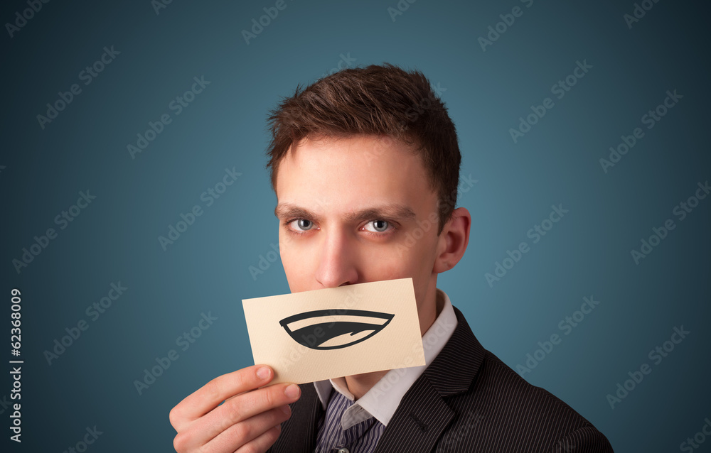 Happy businessman holding funny white card on his mouth Happy businessman holding funny white card on his mouth