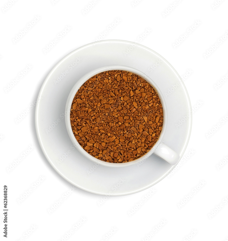 granules of instant coffee in a white cup and saucer isolated on granules of instant coffee in a white cup and saucer isolated on