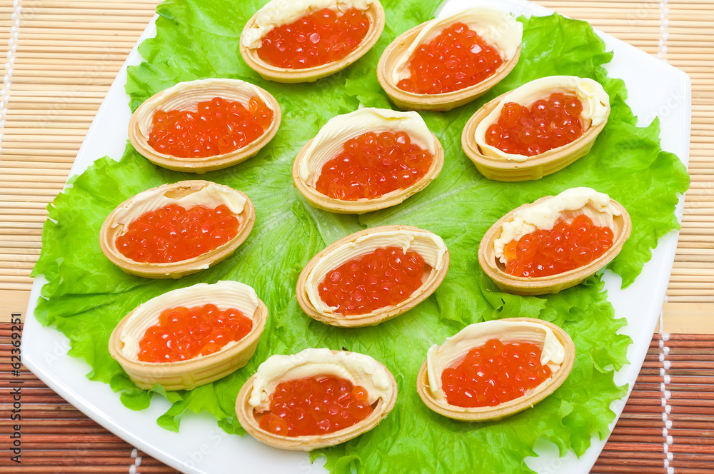 Tartlets with red caviar and butter on a plate Tartlets with red caviar and butter on a plate