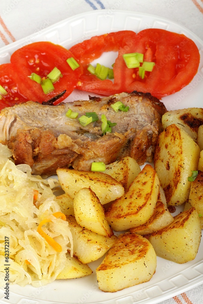 pork with roasted potatoes, tomatoes and sauerkraut pork with roasted potatoes, tomatoes and sauerkraut