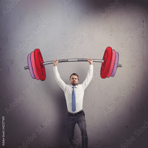 Businessman lifting barbell