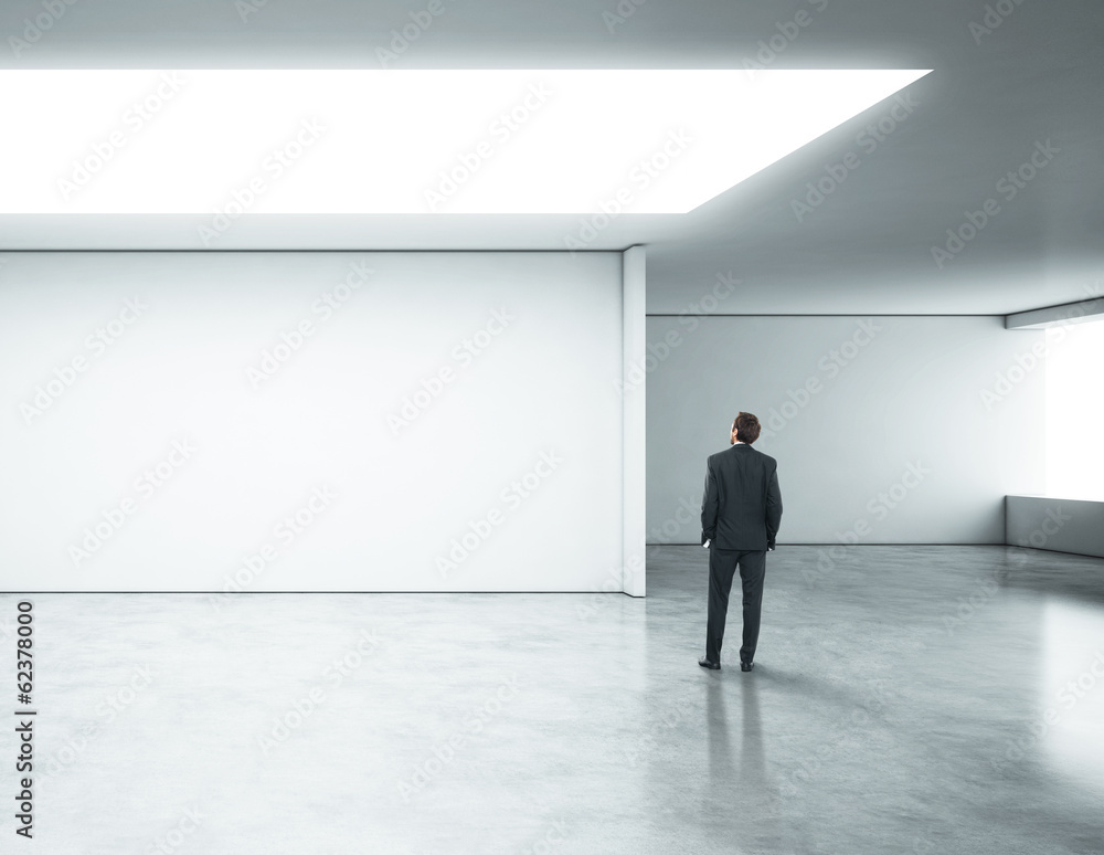 businessman standing in bright office businessman standing in bright office