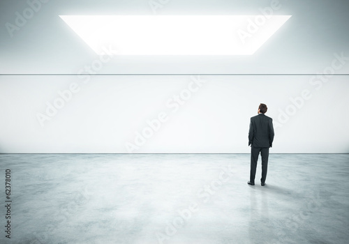 businessman standing in bright office