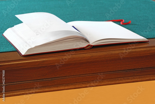 Принти на полотні Open guestbook on the table with green cloth