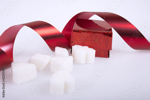 Gift, sugar cubes with red ribbon.