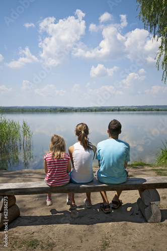 Kids sitting on the lakeside
