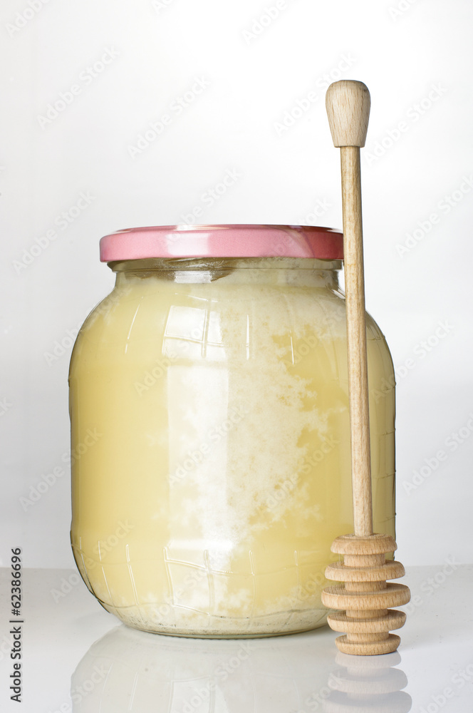 Pot of honey on the bright background Pot of honey on the bright background