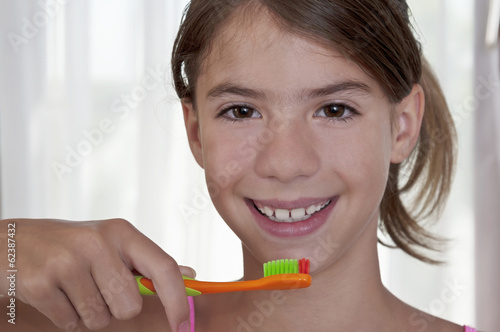 Brushing teeth in bathroom