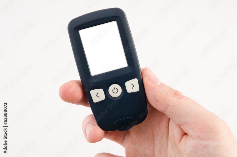 Hand holding glucometer with blank display isolated Hand holding glucometer with blank display isolated