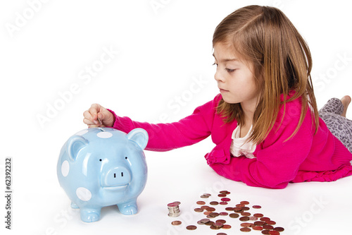 Child Saving money in a piggy bank