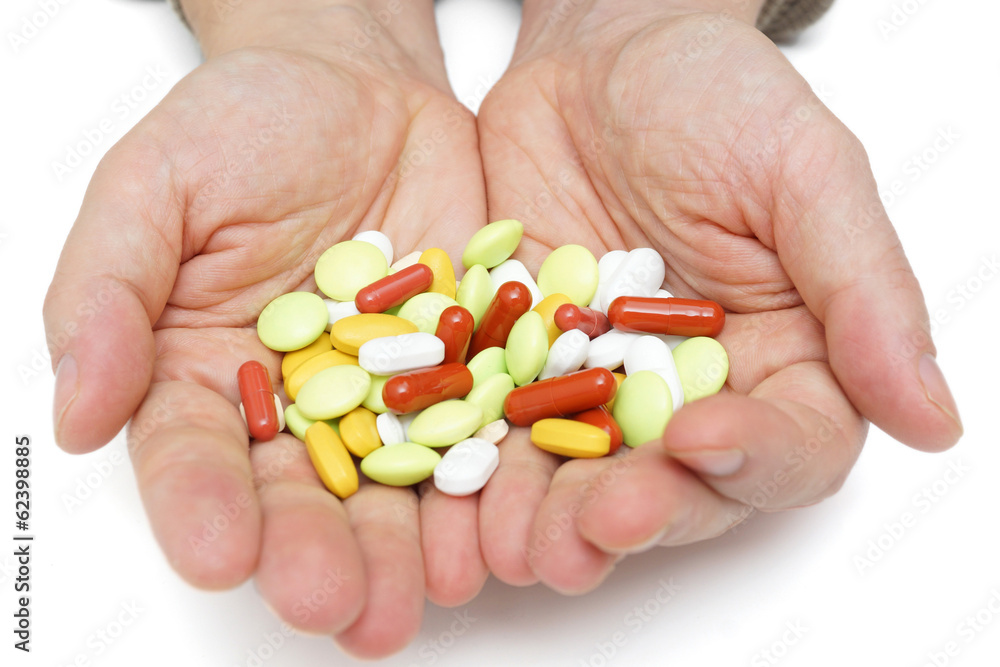 Hand with colorful pills, over dosing with medicals Hand with colorful pills, over dosing with medicals