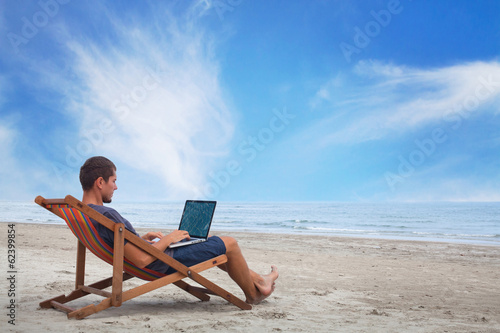 businessman working with computer on the beach