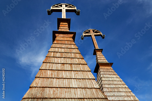 Brown wooden cross against blue sky photo