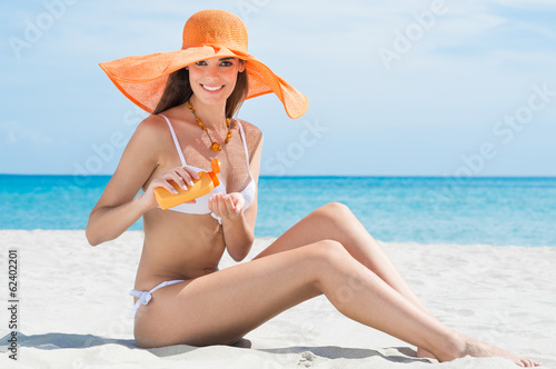 Woman At Beach With Moisturizer