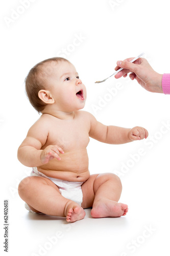 mom feeding baby  with a spoon
