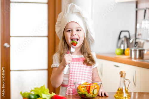 Chef kid tasting healthy food