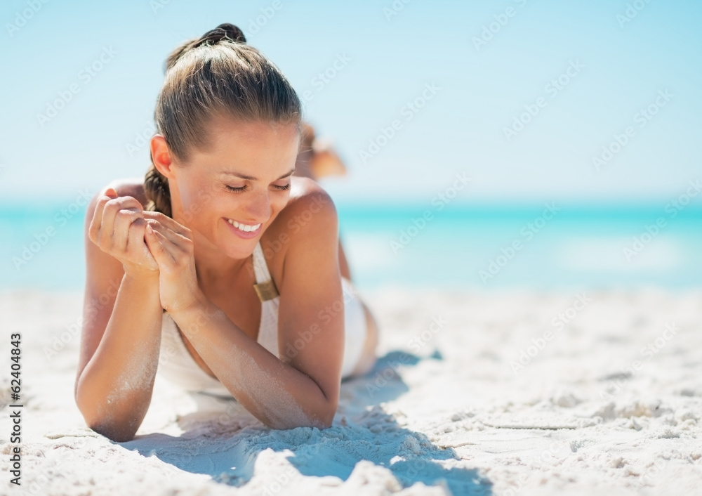 Happy young woman laying on beach Happy young woman laying on beach