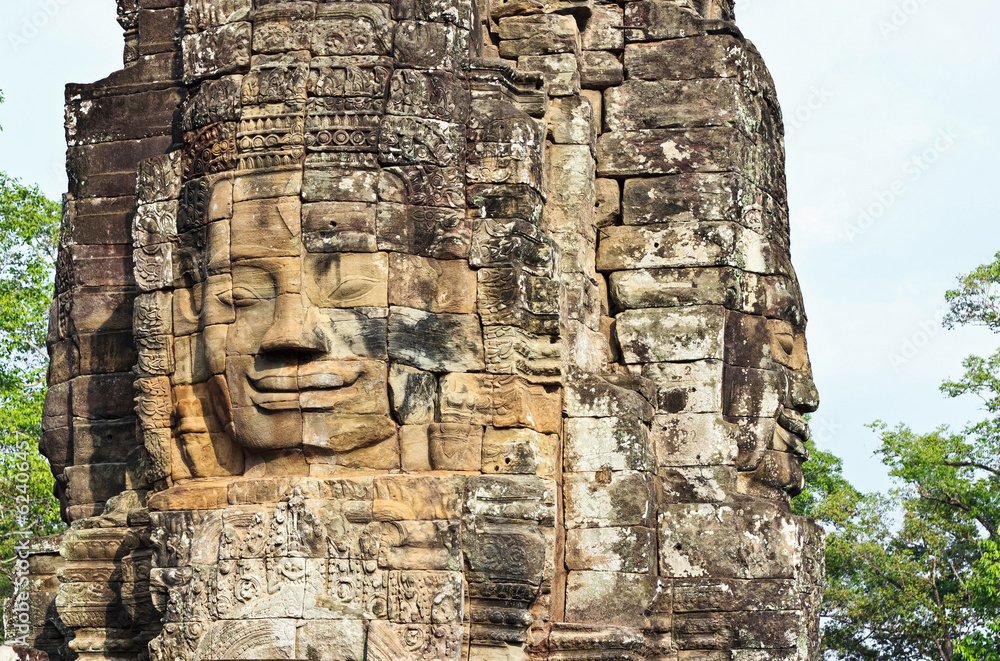 Stone head of Buddha on towers of Bayon temple in Angkor Thom