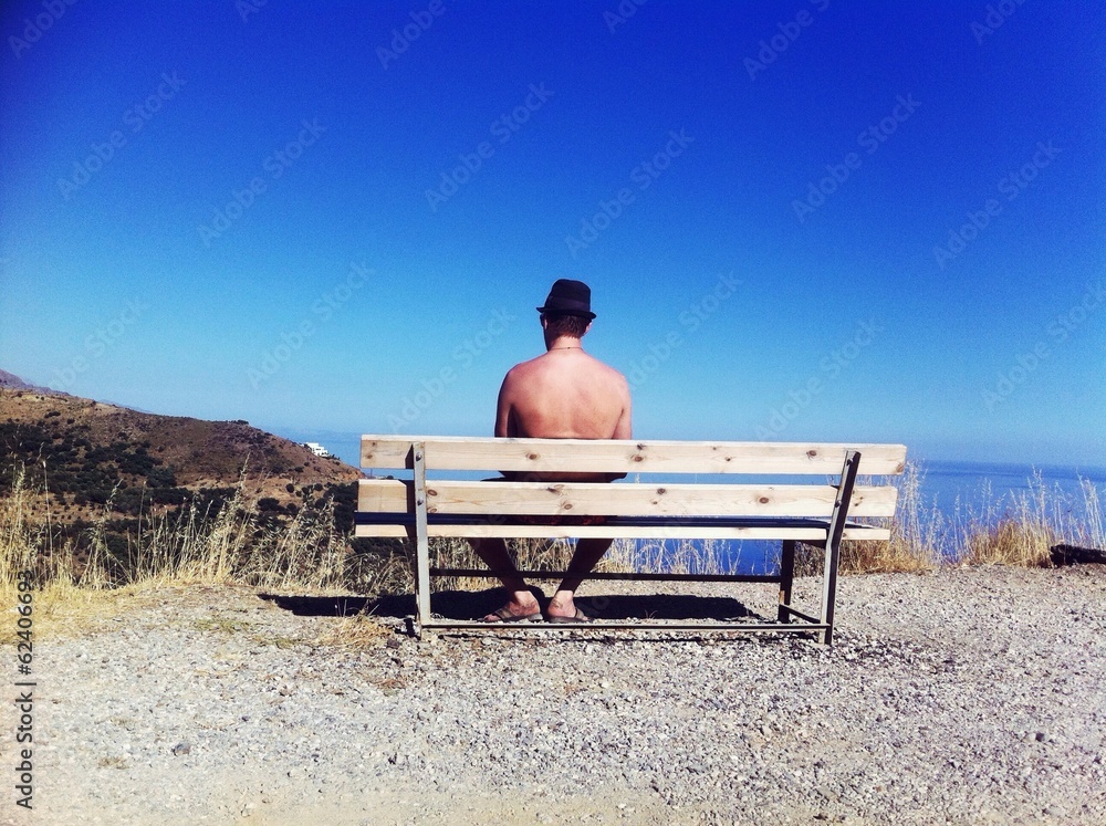 lonely man sitting on the bench looking at the sea lonely man sitting on the bench looking at the sea