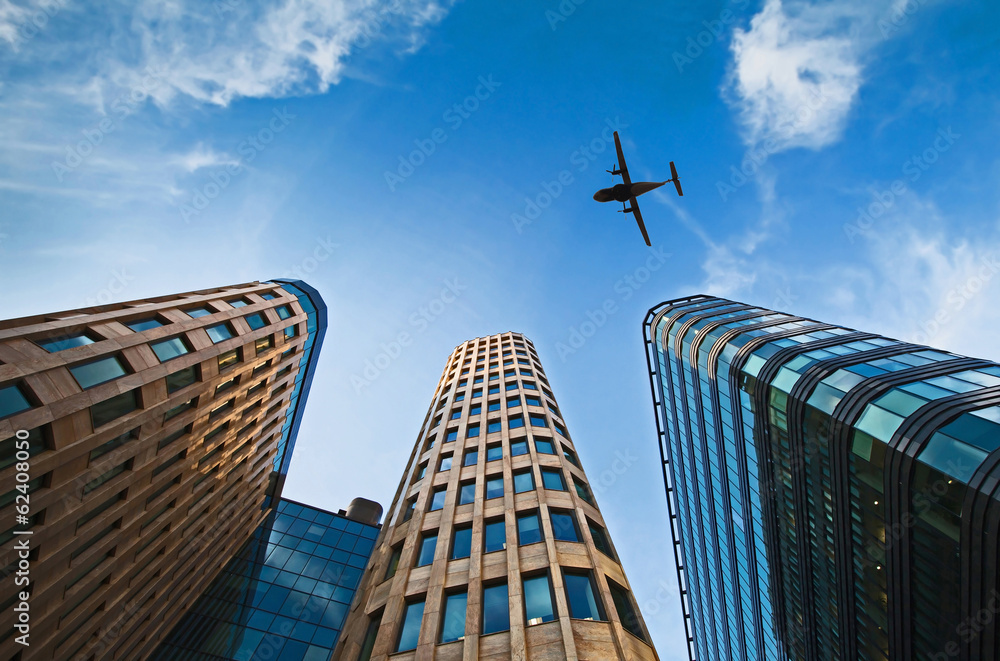 plane over office buildings