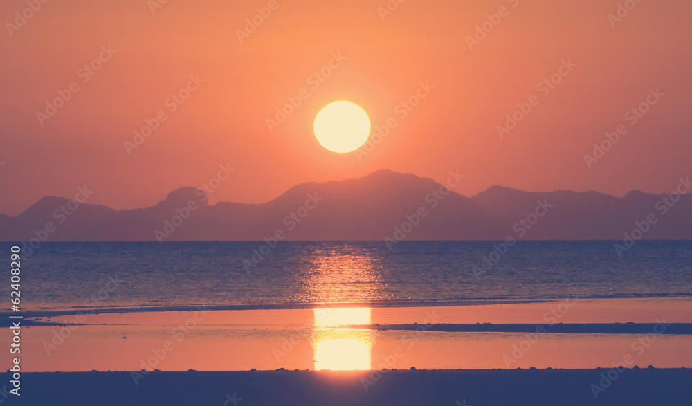 Vintage sunset over tropical sea and island,filtered image