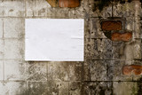 Blank white poster on grunge wall