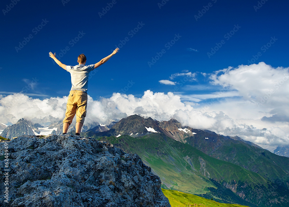 Tourist on mountain peak. Sport and active life