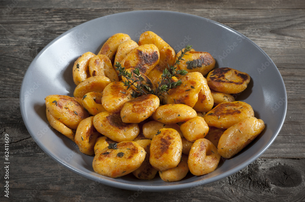 pumpkin dumplings italian gnocchi with thyme on plate pumpkin dumplings italian gnocchi with thyme on plate