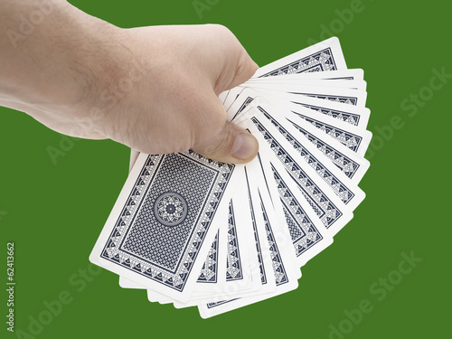Man hand holding cards on green background with clipping path