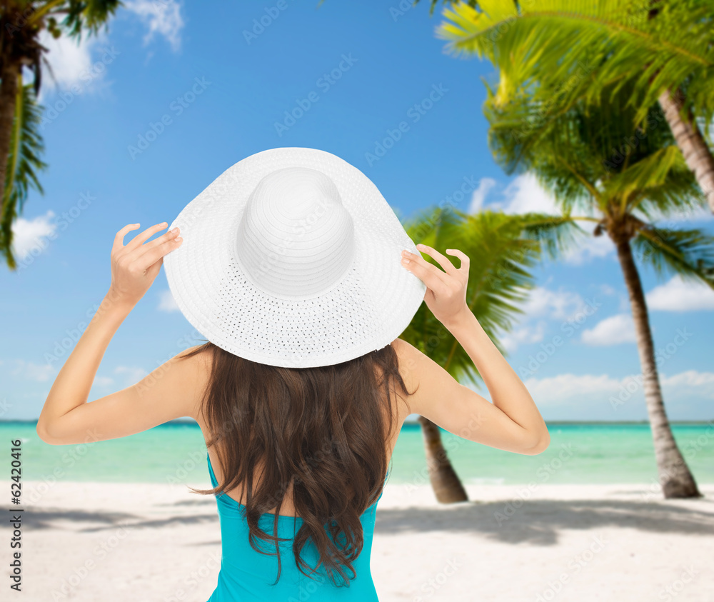 woman sitting in swimsuit with hat