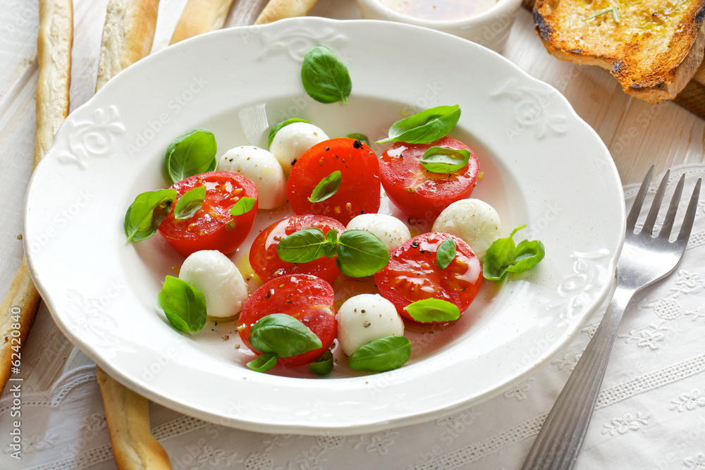 Caprese salad; mini mozzarella, cherry tomatoes and basil Caprese salad; mini mozzarella, cherry tomatoes and basil