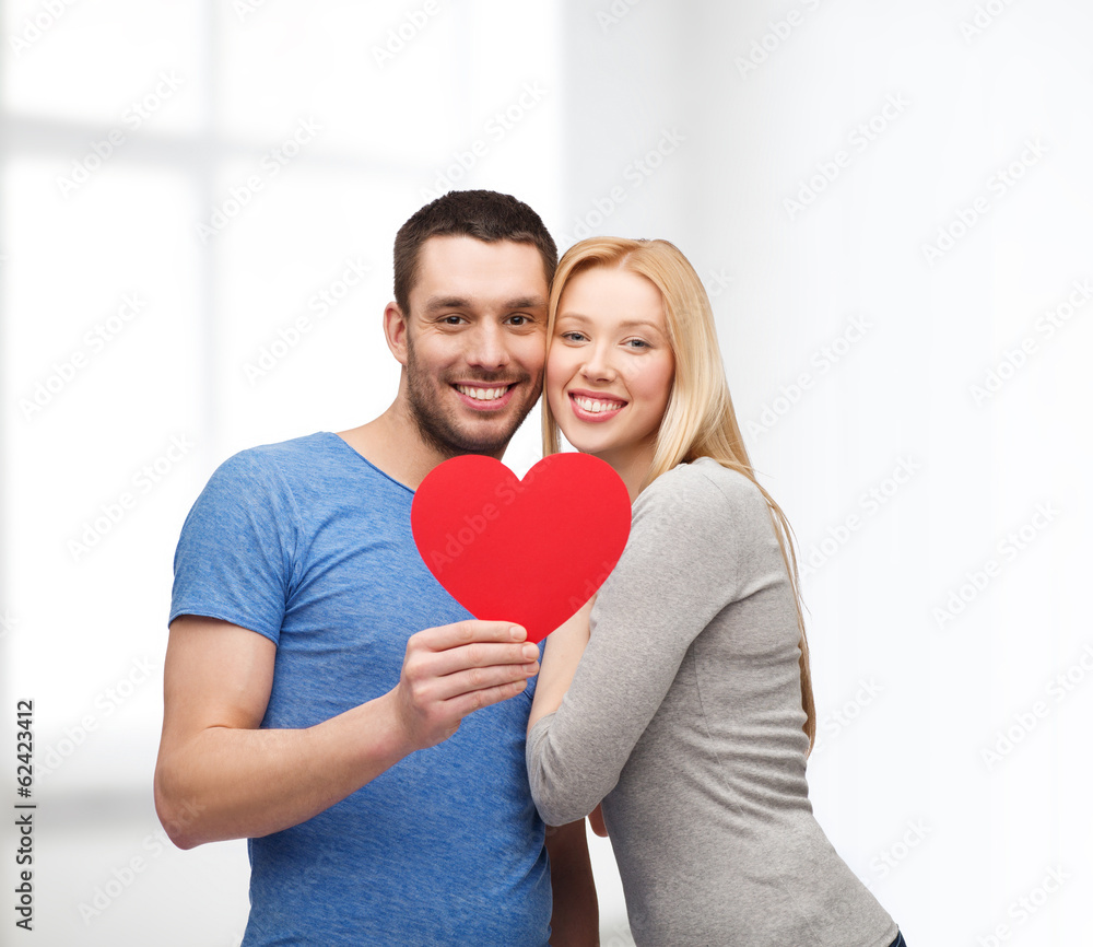 smiling couple holding big red heart