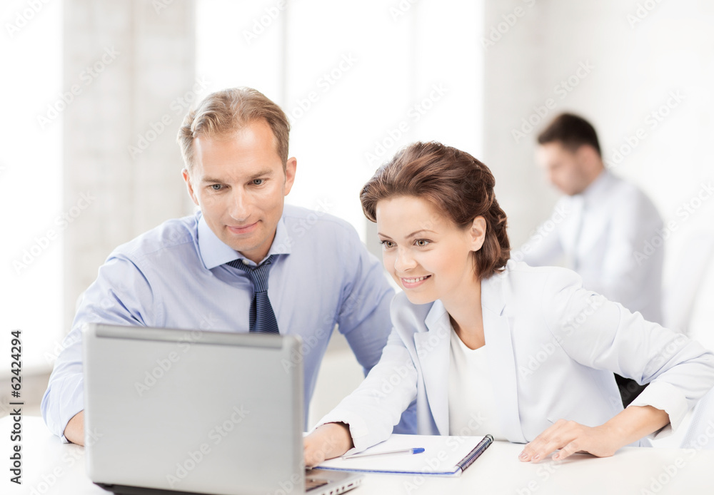 man and woman working with laptop in office man and woman working with laptop in office