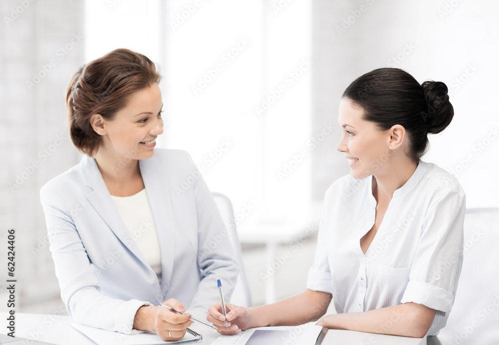 two businesswomen having discussion in office two businesswomen having discussion in office