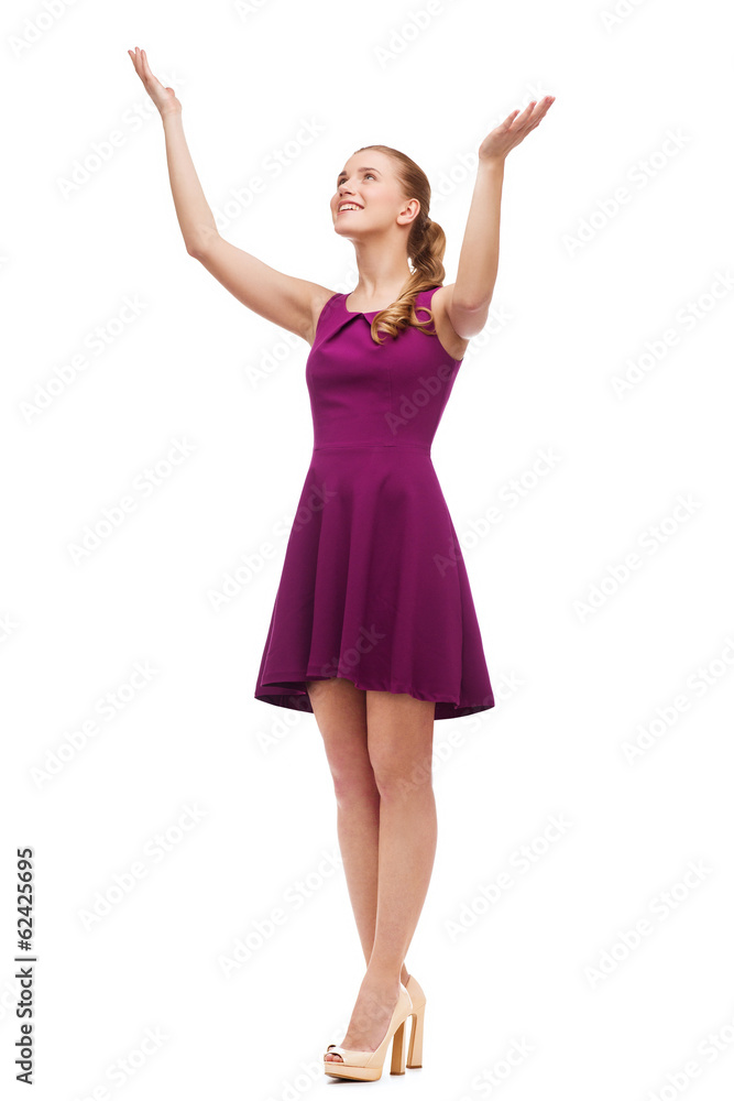 smiling young woman in dress waving hands smiling young woman in dress waving hands